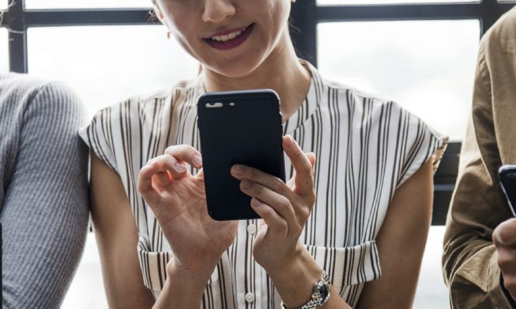 woman checking email on smartphone