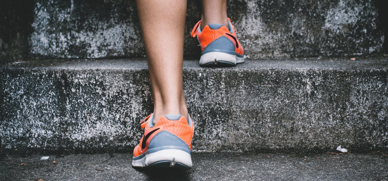 person taking healthy steps up stairs